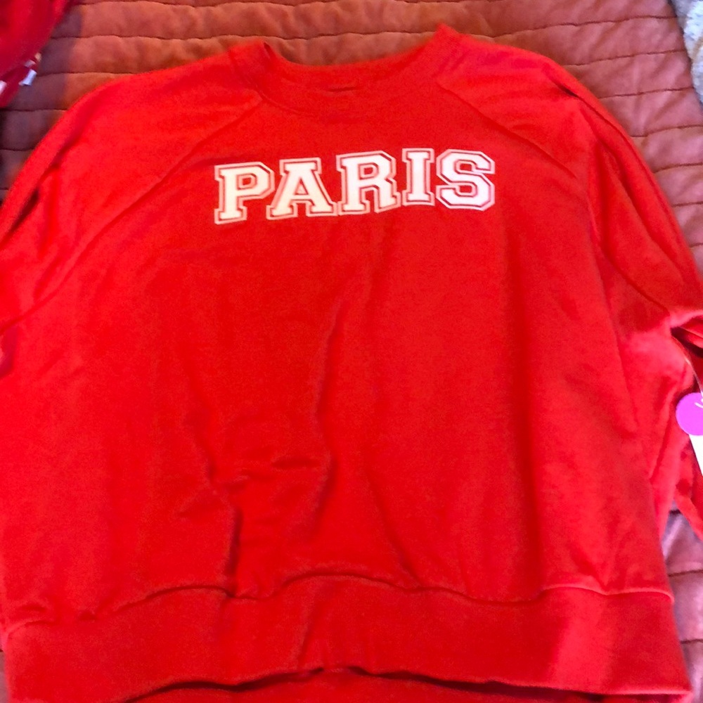 Red sweatshirt that says Paris on it.
